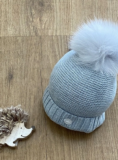 Chubby knit hat in various colors. It wears a natural fur pompom.