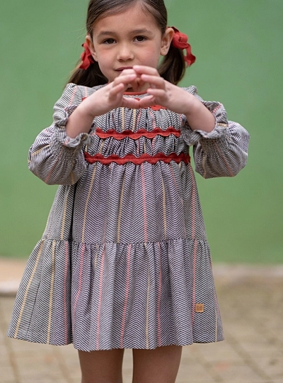 Girl's dress from the Nuez collection, herringbone check pattern with terracotta details