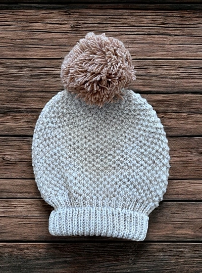 Knitted hat with pompom. Mistral Collection