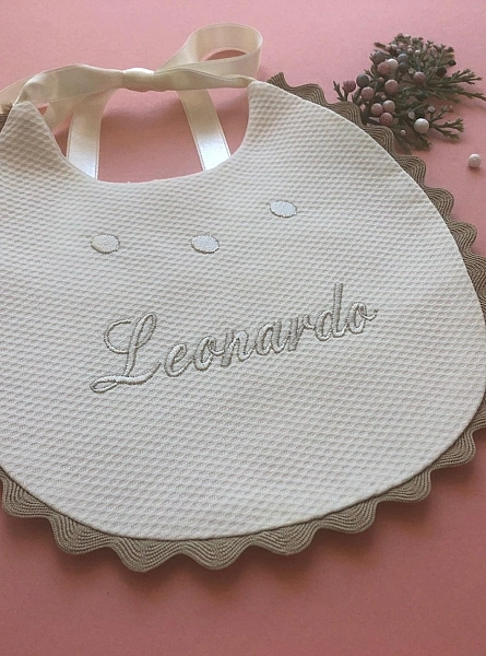 Pique bib with embroidered name. Various colors
