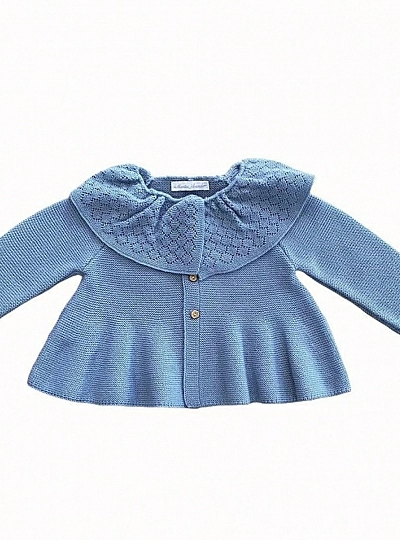 Powder blue jacket with ruffled collar.